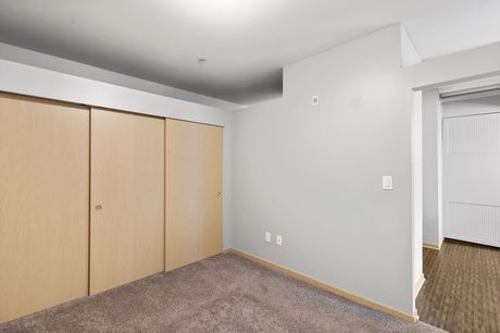 A bedroom with sliding closet doors